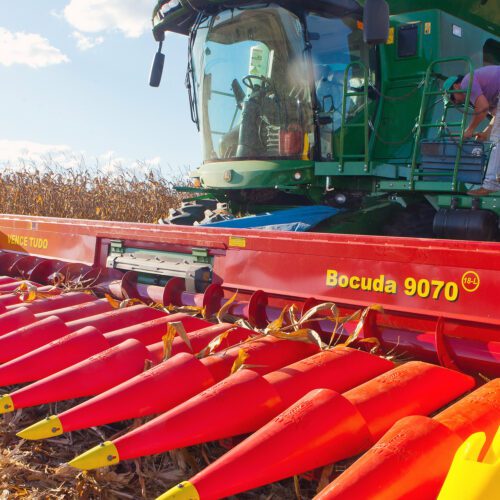 Woman standing on large agricultural machine