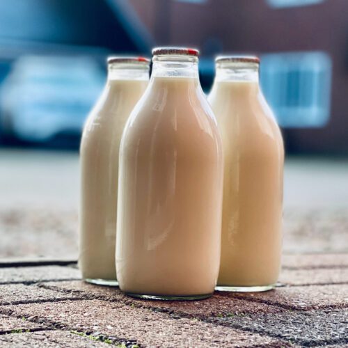 Three milk bottles on the ground