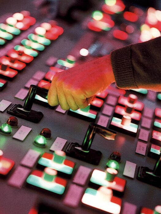 A technician using the control desk in a nuclear power station.
