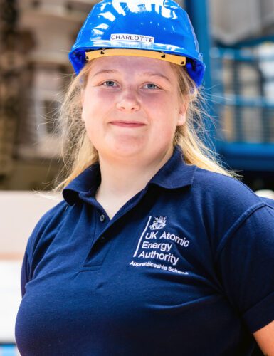 Charlotte in blue t-shirt and hard hat