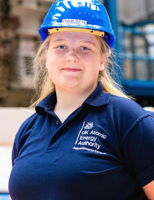 Charlotte in blue t-shirt and hard hat