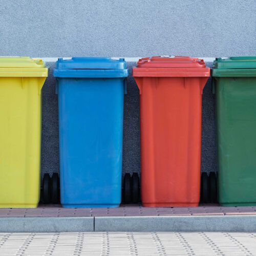 Four different coloured rubbish bins