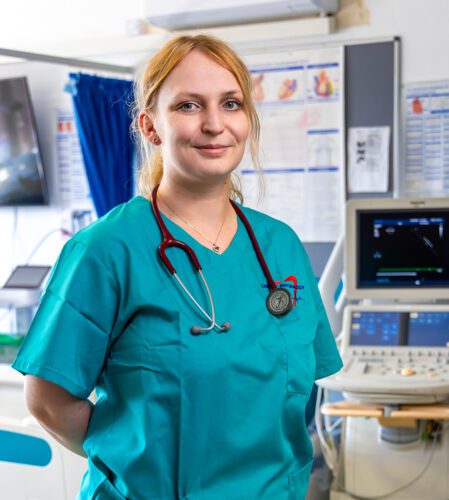Agnieszka in a hospital with a wearing hospital scrubs