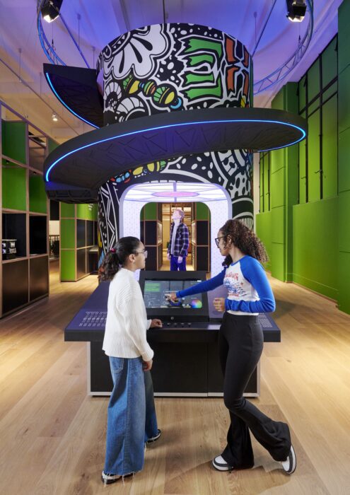 Two visitors try out an interactive exhibit at the Science Museum.