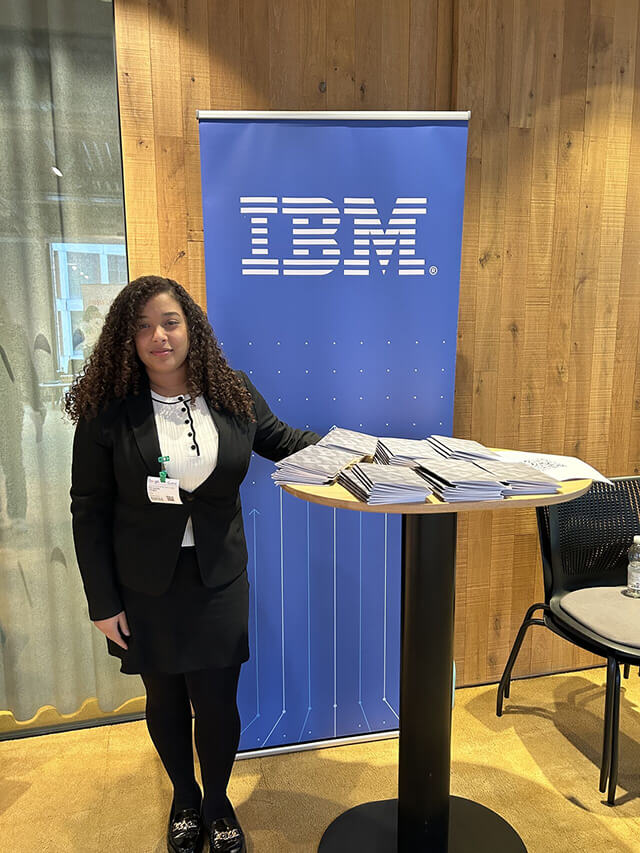 Ferndanda stood infront of an IBM posters