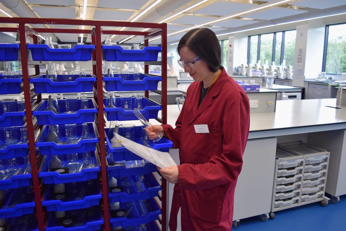 Jasmine checking the stock of glassware in the laboratory.