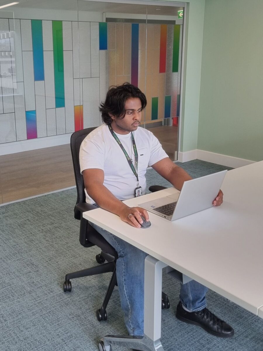 Dericson working on his laptop in the office.