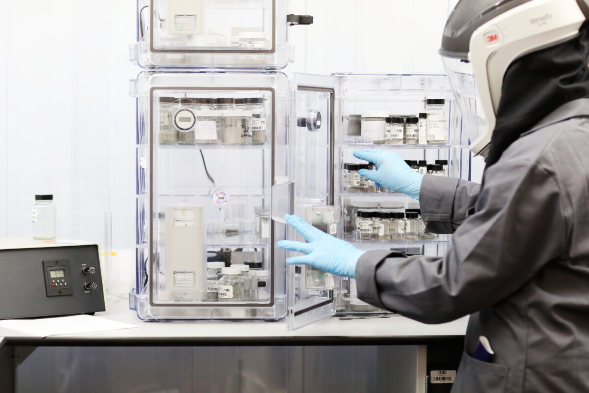 Engineer in helmet and protective clothing working in lab