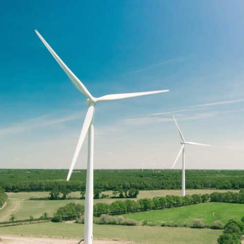 Two wind turbines in fields